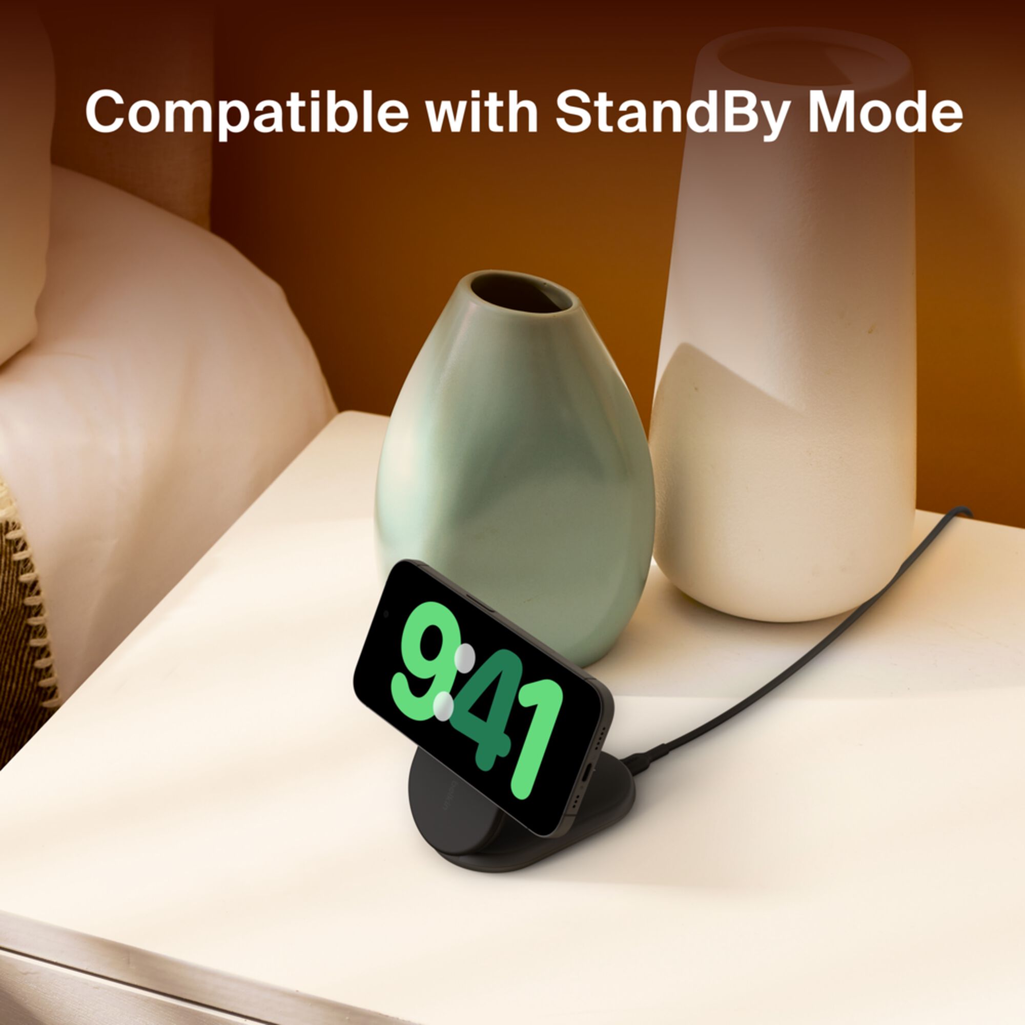 Black Belkin BoostCharge Qi2 15W magnetic foldable wireless charging stand holding an iPhone upright. — view 5