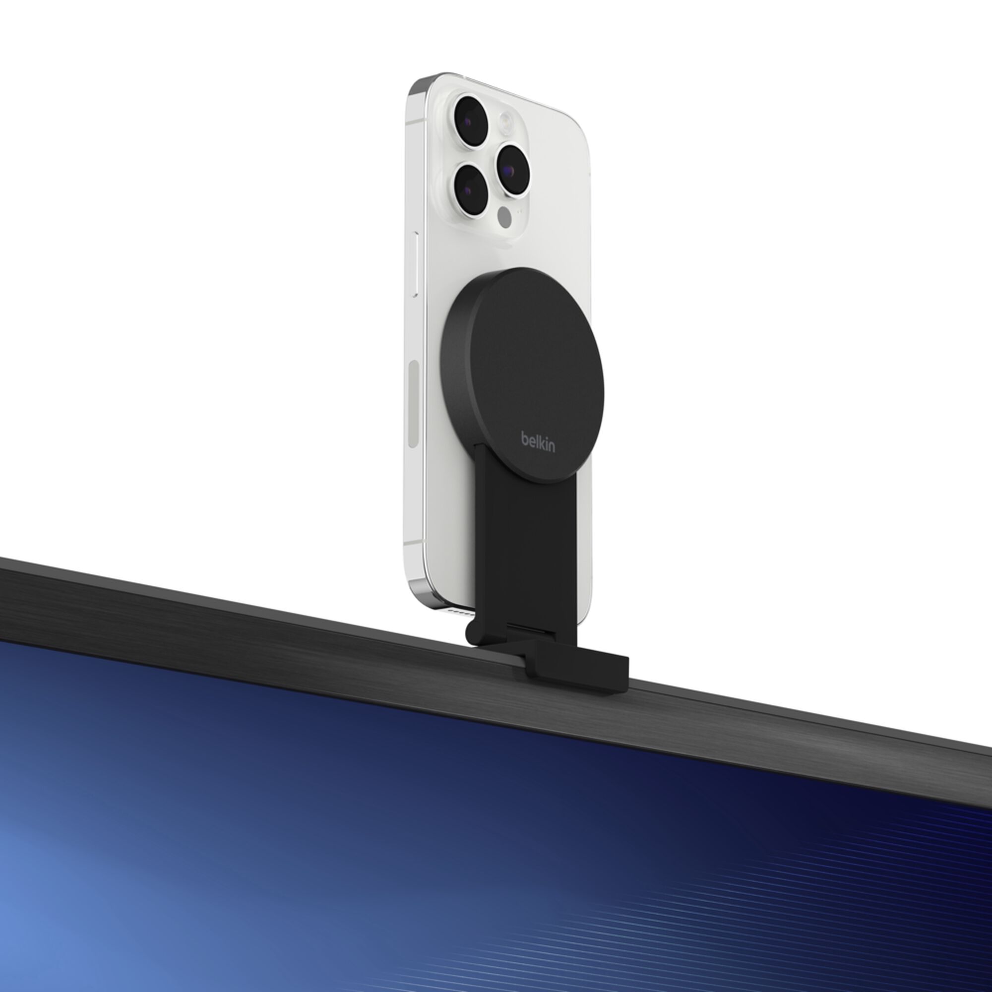 Grey Belkin iPhone Mount with MagSafe perched on top of a TV, holding an iPhone as a webcam for Apple TV 4K. — view 8