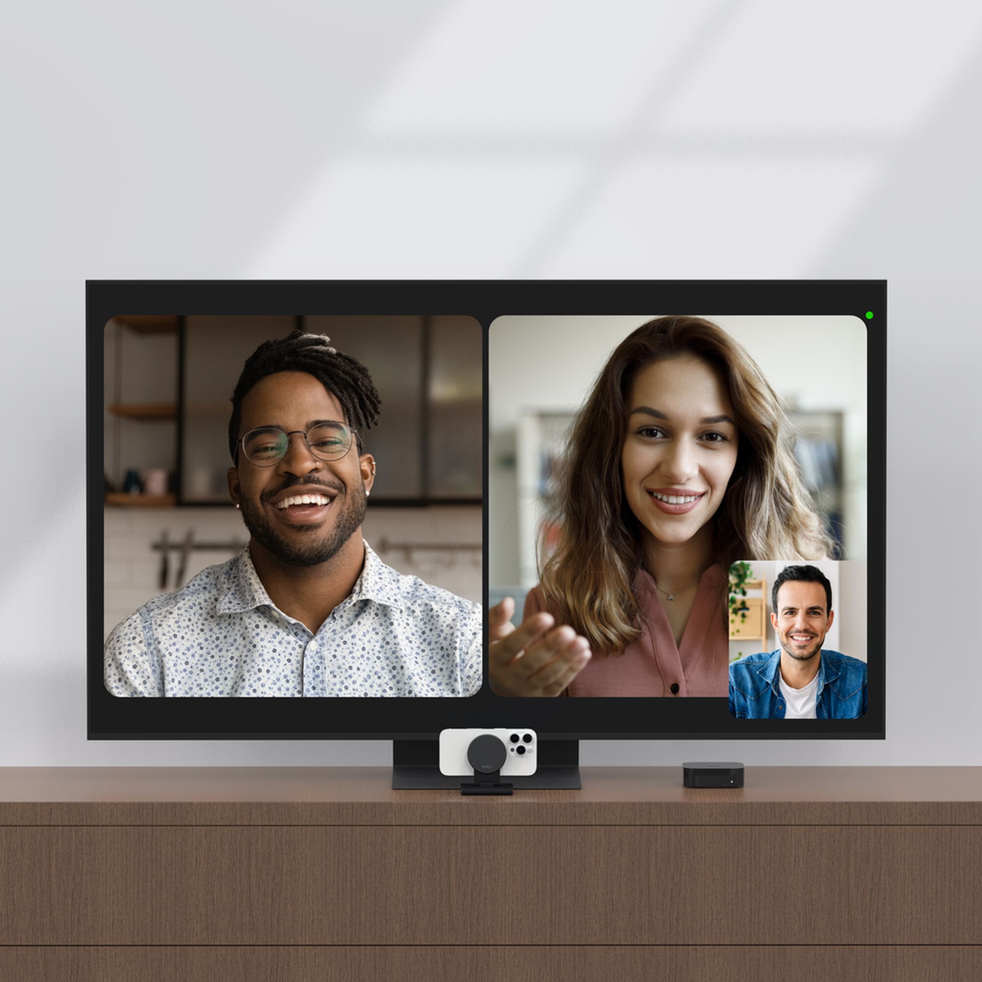 Grey Belkin iPhone Mount with MagSafe perched on top of a TV, holding an iPhone as a webcam for Apple TV 4K. — view 15
