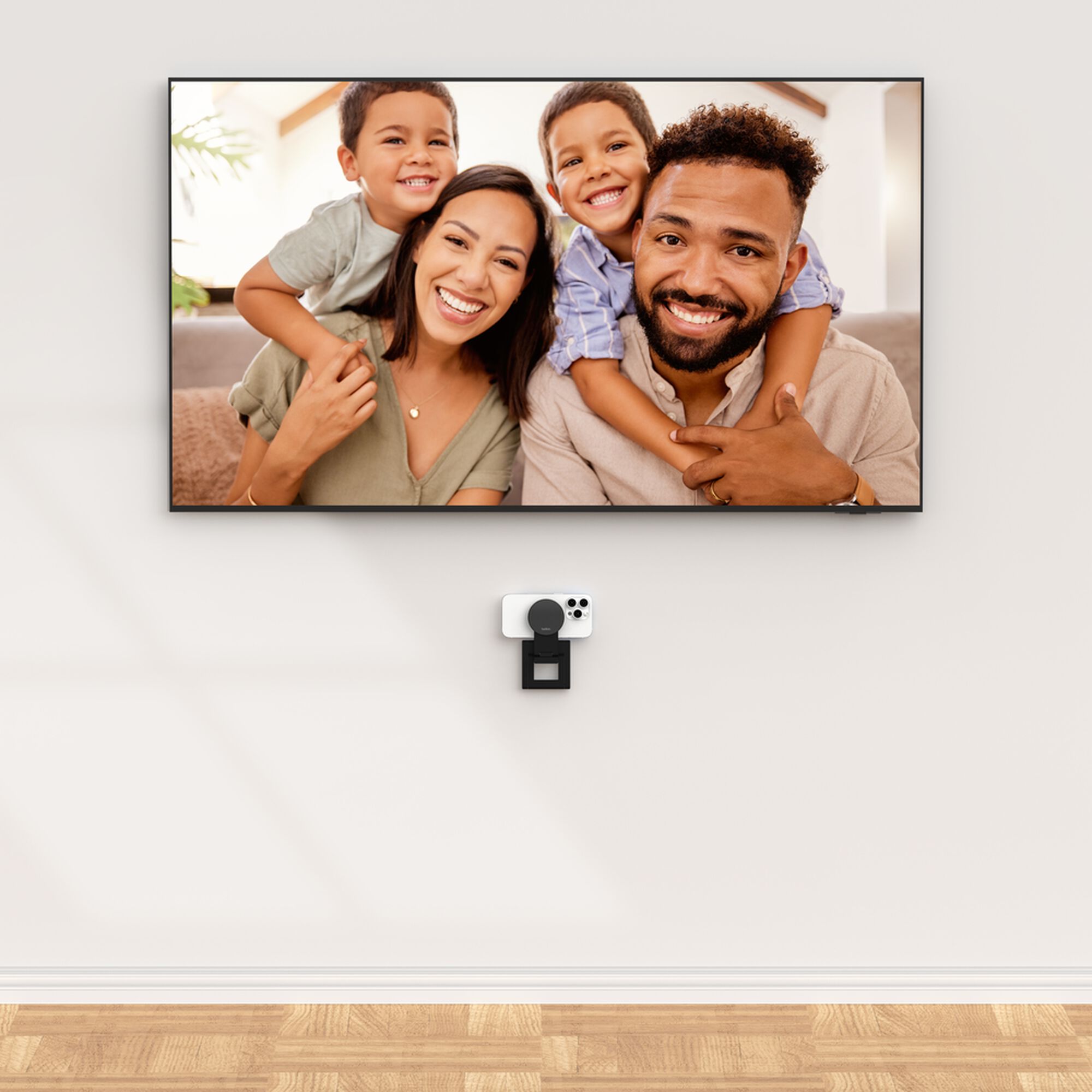 Grey Belkin iPhone Mount with MagSafe perched on top of a TV, holding an iPhone as a webcam for Apple TV 4K. — view 14