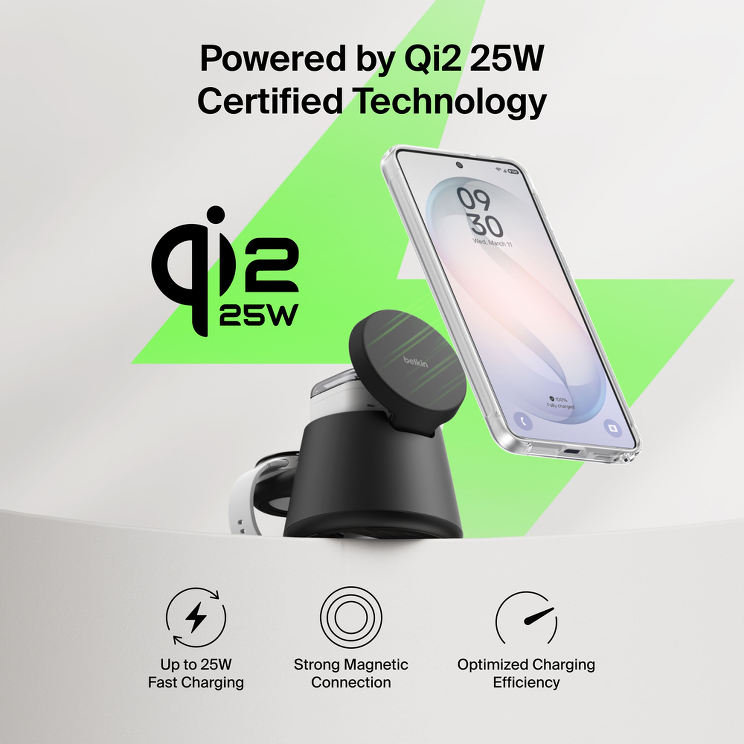 Black Belkin UltraCharge 3-in-1 modular charging dock with a phone on the Qi2 pad, earbuds on the lower pad and a smartwatch on the rear holder. — view 7